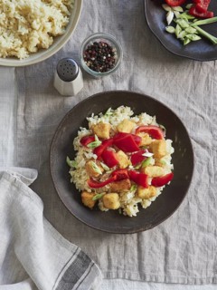 Rice, red bell pepper, spring onion and chicken dish on the table. View from above