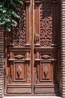 A beautifully carved wooden door in Tbilisi, featuring ornate patterns and detailed craftsmanship.