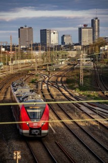 Train on the tracks west of Essen central station, city centre skyline, regional express train,