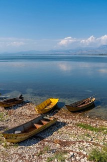 Colorful boats in the beautiful landscape in Shiroka on Lake Shkoder. Albania
