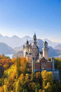 Impressive Neuschwanstein Castle with a mountainous and autumnal backdrop, Schwangau, Ostallgäu,