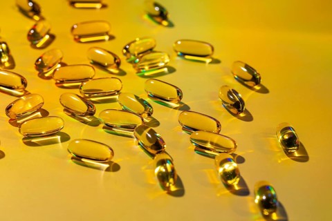 A vivid display of softgel capsules showcases their potential as a health supplement rich in