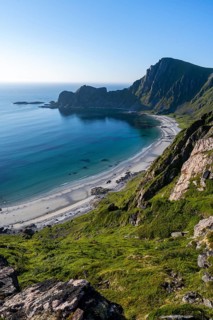 View of coastal landscape, cliffs with peak Måtind or Måtinden, Høyvika beach and sea, hike to the