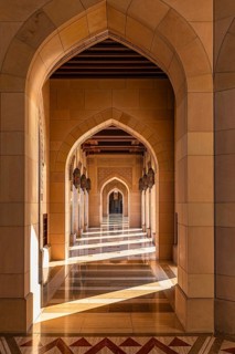 Sunlit arcade of the Sultan Qaboos Mosque, Muscat, Arabian Peninsula, Sultanate of Oman