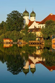 Romanesque Benedictine Abbey Seeon Monastery, monastery church St. Lambert with reflection in the