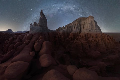 A mesmerizing view of Goblin Valley State Park under a starry sky. The unique sandstone formations