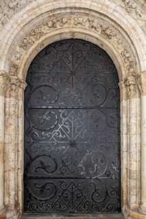 Wooden door decorated with wrought-iron fittings, magnificent entrance to the medieval Temple