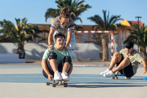 A teenager with Down syndrome enjoys sports with his family, promoting inclusion and joy They