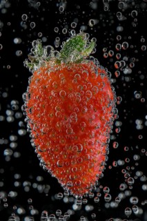 Strawberry with air bubbles in water, Germany