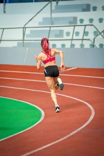 Athlete sets off on a sprint, with focus and speed in a modern stadium, Glaspalast, Sindelfingen