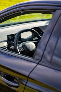 Modern car interior with steering wheel and digital screens, e-car sharing, Deer Mobility, MG4,