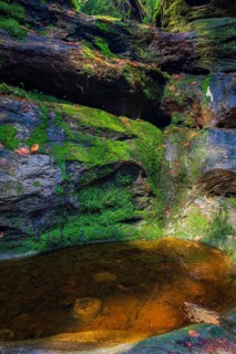 Glacial pothole filled with water at the Schwedenlöcher, a narrow gorge of the Amselgrund near the