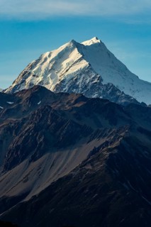 Stunning autumn view of Mount Cook, New Zealand, showcasing its snow capped peak under a clear blue