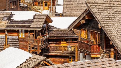 Snow-covered old farmhouses with balconies, historic town center, Grimentz, Val d'Anniviers, Valais