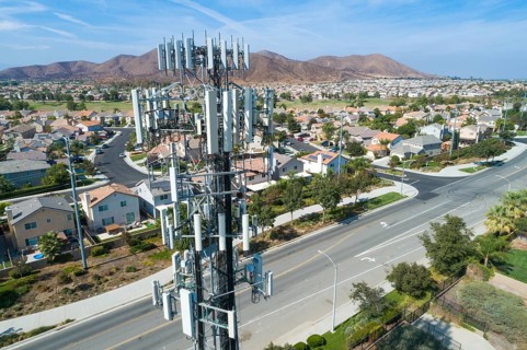 Close-up Aerial of Cellular Wireless Mobile Data Tower with Neighborhood Surrounding