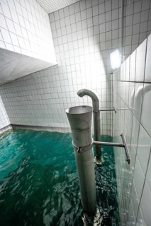 Industrial water basin with tiled walls and simple steel pipes, ENCW Netze Calw waterworks, Calw,