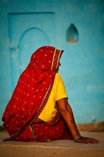 KHAJURAHO, INDIA, APRIL 15, 2011: Indian rural woman in traditional sari sitting in Khajuraho