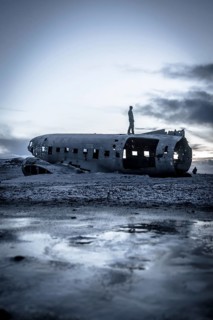 A man on the crashed military plane in Solheimasandur in winter