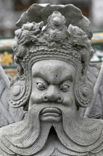 Stone statue of a Chinese warrior, guardian, Wat Arun, Temple of Dawn, Bangkok, Thailand