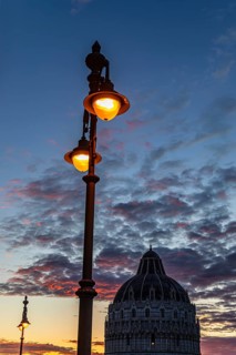 Baptistery Baptistery in the evening light under an illuminated street lamp at sunset, Pisa