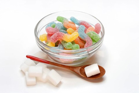 Lots of colorful jelly candies and sugar cubes, sugar consumption