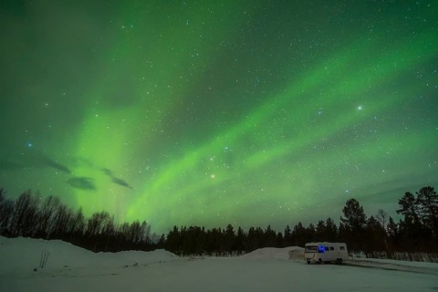Stunning display of the Aurora Borealis near Kiruna, Sweden. The sky glows with breathtaking,