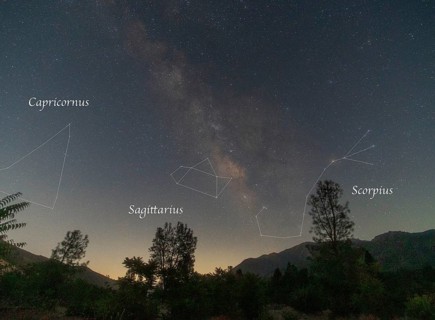 A spectacular night sky over Sequoia National Park, featuring the Milky Way with constellation