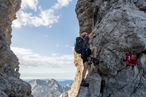 Mountaineer climbs at the start of the Via Ferrata Bocciere Centrale via Ferrata Bocciere Centrale