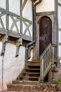 Wooden door with staircase on a rustic half-timbered building, Wartburg Castle near Eisenach in