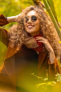 Close-up vertical portrait of a sensual woman in a park during autumn