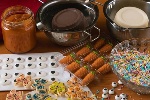 Various ingredients to decorate cookies, such as sugar eyes, carrots and colorful sprinkles
