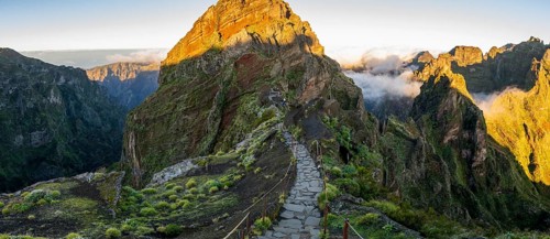 Sunrise at Pico do Arieiro, clouds of fog pass over mountain peaks, hiking trail PR1, Madeira,
