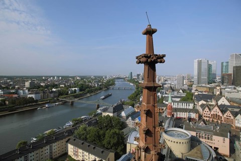 View from Kaiserdom on cityscape, river with cargo ship, skyscrapers, pinnacles, cruciflower,