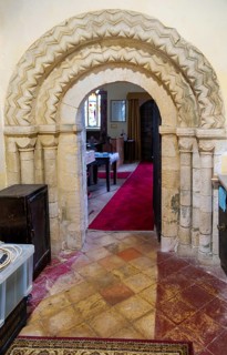 Chevron zig-zag pattern of Norman arched doorway inside church of Saint Peter, Theberton, Suffolk,