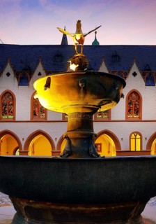 View from the market fountain to the late Gothic town hall of Goslar in the evening, Old Town,