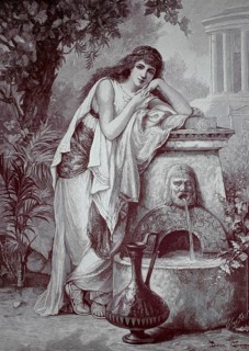 At the spring, young woman leaning on a well with water flowing from the mouth of the fountain