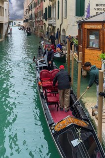 Tourists board gondola for round trip, Venice, Veneto, Italy