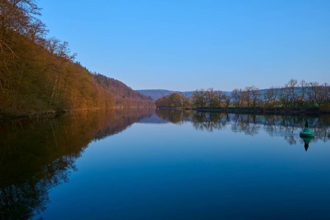 Clear river under blue sky, along wooded shore, peaceful atmosphere, Boxtal, Main-Boxtal, Tauber