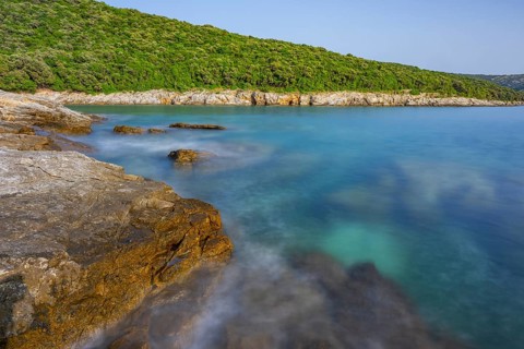 Crystal clear and turquoise water on the beach of Ustrine Bay on a sunny day on the island of Cres,