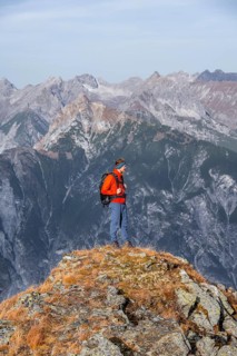 Mountaineers in front of a mountain panorama, view from the ridge of the Venet to mountains of the
