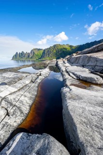 Reflection in a tidal pool, rocky coast of Tungeneset, Devil's Teeth, Okshornan, Ersfjorden, Senja