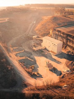 Quarry with large building and machines in warm lighting, Magstadt, Germany