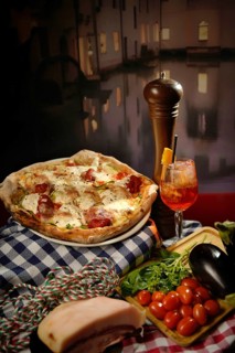 A delicious bustling Italian pizza adorned with mozzarella and ripe cherry tomatoes, laid out