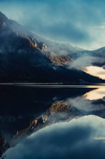Sunrise with reflections in the Plansee in Tyrol in the Alps in Austria