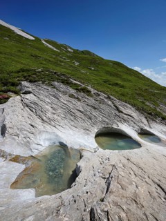 Glacier mill with glacier pots on the Trinser Alp Mora, Trin, Canton Graubünden, Switzerland