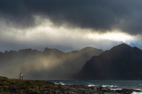 Sunbeams over coastal landscape and sea, Lofoten, Nordland, Norway, September 2020