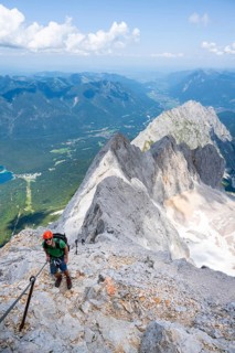 Mountaineer with helmet in a secured via ferrata, Zugspitz via ferrata, ascent to the Zugspitze,