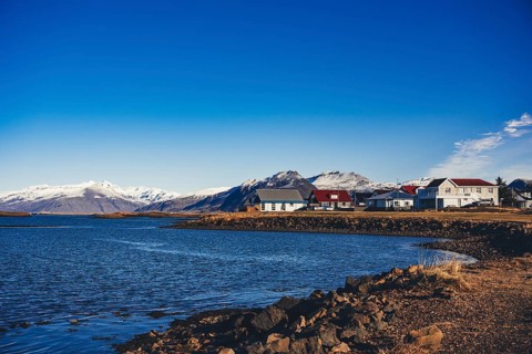 Picturesque coastal village in Stokksnes, Iceland, with brightly colored houses along a rocky