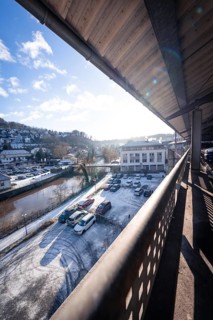 Car park deck and surroundings in winter with snow residues on cars and sunny sky, Kaufland Calw