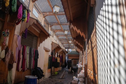 Traditional Moroccan street with typical clothing stores from the city of Fez. The solitary scene